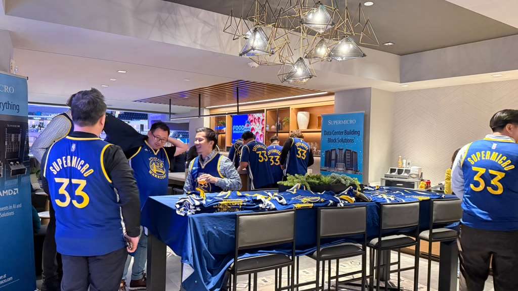 Guests in custom Supermicro number 33 Warriors jerseys in a private suite lounge