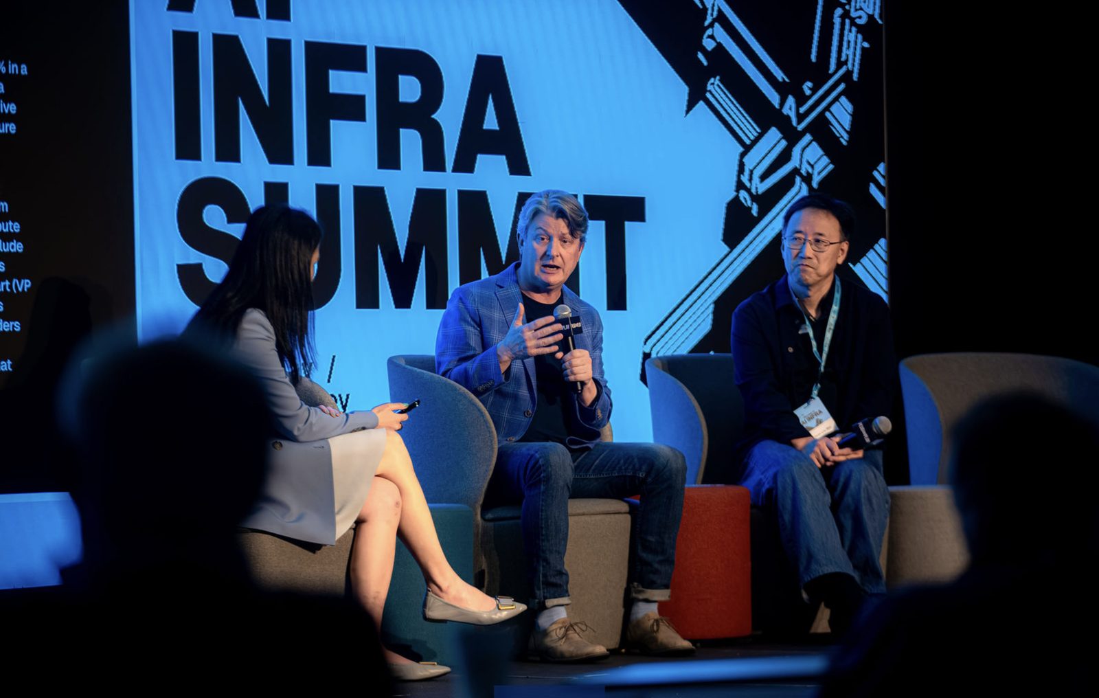 Panel on the AI INFRA SUMMIT main stage in front of the summit LED wall