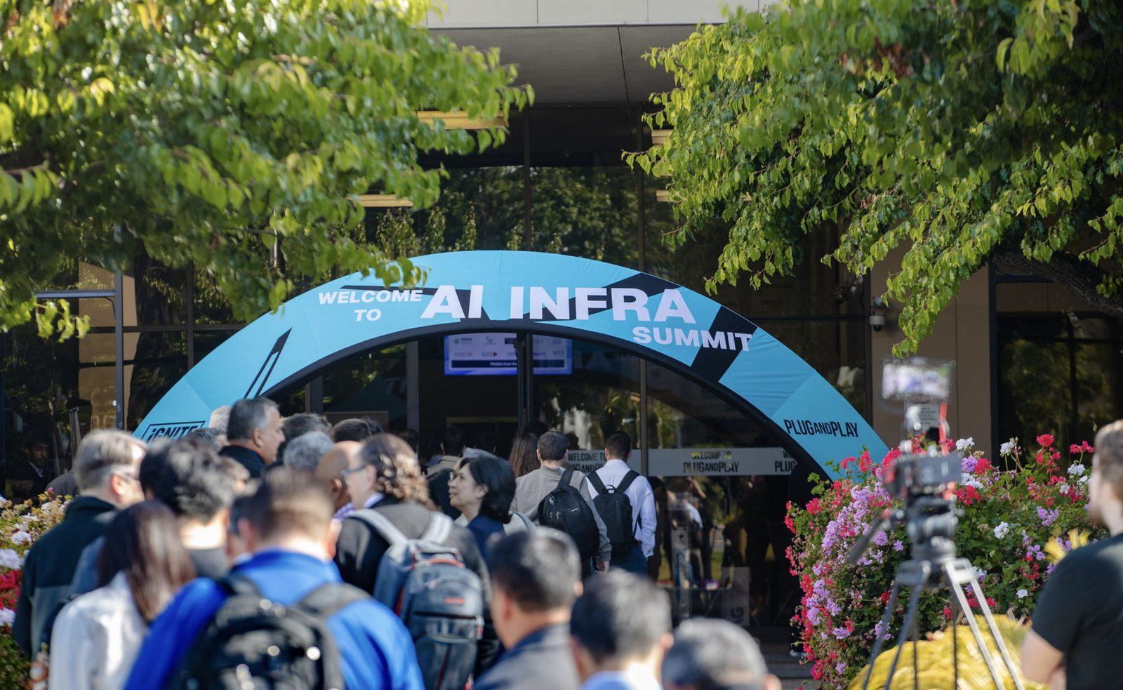 Attendees arriving under the Welcome to AI INFRA SUMMIT arch