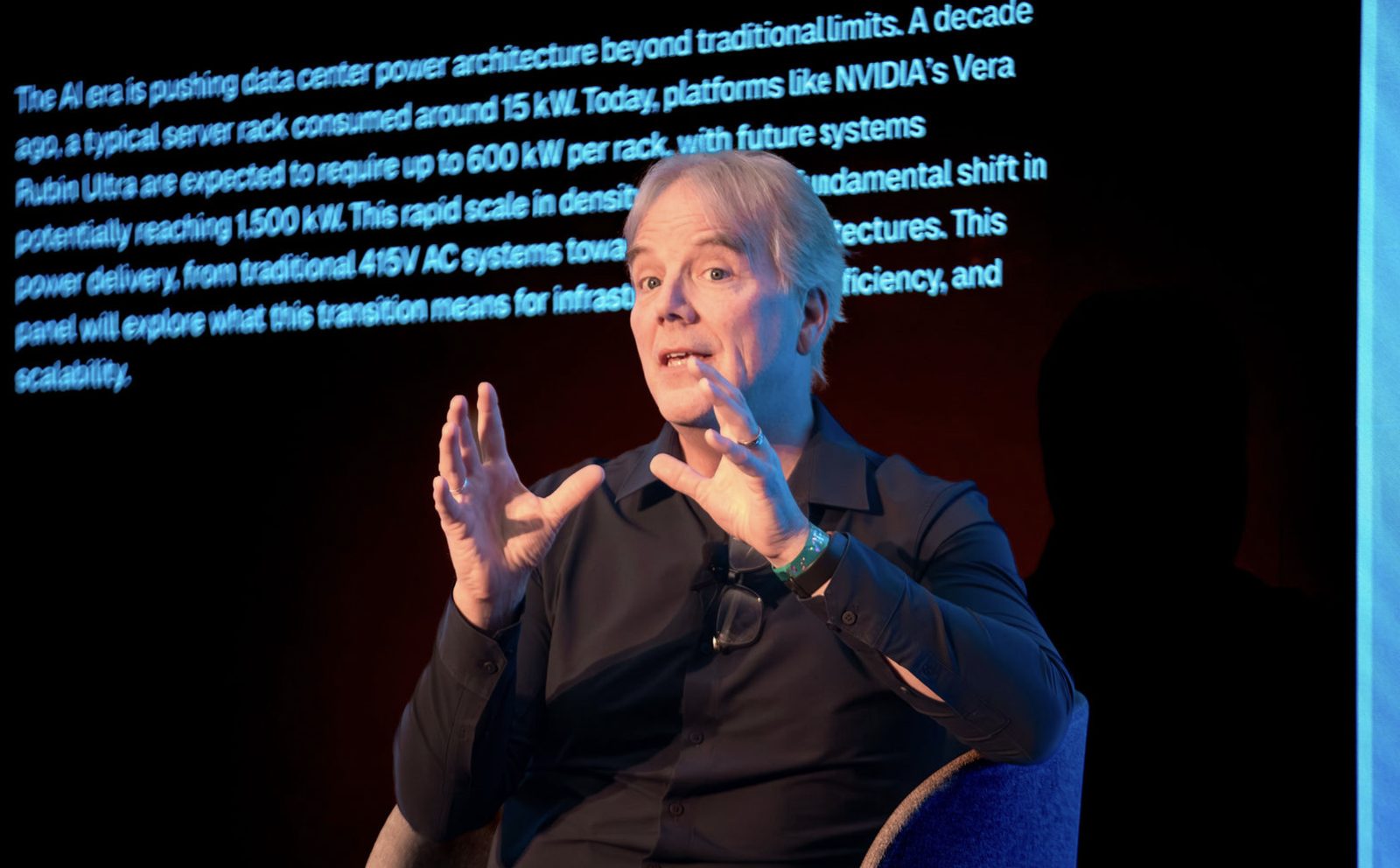 Speaker mid-keynote in front of an LED wall at an IgniteGTM summit